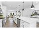 Open-concept kitchen features a center island, stainless steel appliances, and seamless flow to living area at 142 Benson Village Dr # 82, Benson, NC 27504