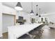 A well-lit kitchen features a large island with pendant lighting and seating, flowing into the living space at 142 Benson Village Dr # 82, Benson, NC 27504