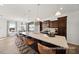 Stylish kitchen features a granite island with seating, dark cabinetry, and an open view to dining area at 142 Benson Village Dr # 82, Benson, NC 27504