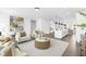 Open concept floor plan with neutral furniture, white walls, island with seating and stainless appliances at 142 Benson Village Dr # 82, Benson, NC 27504