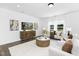 Bright living room with white walls, neutral furniture, white rug, large windows and wood floors at 142 Benson Village Dr # 82, Benson, NC 27504