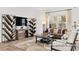 Inviting living room with wood floors, stylish decor, large windows, and comfortable seating arrangement at 142 Benson Village Dr # 82, Benson, NC 27504
