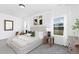 Bright main bedroom with neutral furniture, large windows, wood floors and decorative mirror at 142 Benson Village Dr # 82, Benson, NC 27504