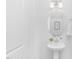 Small powder room features a white pedestal sink and a decorative mirror at 142 Benson Village Dr # 82, Benson, NC 27504