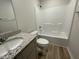 Bathroom with a shower over the tub, vanity with sink and granite counters, and toilet at 159 Coharie Dr, Lillington, NC 27546