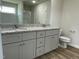 Bathroom includes double vanity with granite countertops, wood-look flooring, and a toilet at 159 Coharie Dr, Lillington, NC 27546