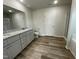 Bathroom features a double vanity with granite countertops, wood-look flooring, and a walk-in shower at 159 Coharie Dr, Lillington, NC 27546
