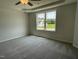 Spacious bedroom featuring a ceiling fan and window that overlooks the landscaped front yard at 159 Coharie Dr, Lillington, NC 27546