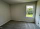 Bedroom featuring neutral walls, carpet flooring, and a window overlooking the front yard at 159 Coharie Dr, Lillington, NC 27546