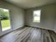 Inviting bedroom with a view to the backyard from the large window, and luxury vinyl flooring at 159 Coharie Dr, Lillington, NC 27546