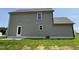 Side view of a two story house with gray siding, a white door, and green grass in the yard at 159 Coharie Dr, Lillington, NC 27546