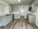 Well-equipped kitchen features modern appliances, sleek countertops, and luxury vinyl flooring at 159 Coharie Dr, Lillington, NC 27546