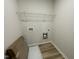 The laundry room includes a wire shelf for storage and connections for the washer and dryer at 159 Coharie Dr, Lillington, NC 27546