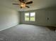 Inviting living room featuring plush carpet, neutral walls, and a ceiling fan for a cozy atmosphere at 159 Coharie Dr, Lillington, NC 27546