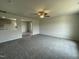 Expansive living room featuring neutral carpet, a ceiling fan and smooth walls, offering a cozy atmosphere at 159 Coharie Dr, Lillington, NC 27546