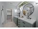 Spa bathroom featuring dual vanities, modern fixtures, round mirrors, and a tiled walk-in shower at 160 Daphine Dr, Hillsborough, NC 27278