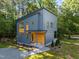 Contemporary home exterior featuring unique architectural design, nestled amongst mature trees and manicured landscaping at 160 Daphine Dr, Hillsborough, NC 27278