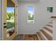 Bright and airy foyer featuring a wood door, stairs, and a view to the outdoors, blending modern style at 160 Daphine Dr, Hillsborough, NC 27278