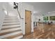 Bright open-concept interior with hardwood floors, stairs, and a view of the living and dining areas at 160 Daphine Dr, Hillsborough, NC 27278