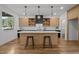 Modern kitchen featuring a large island with seating, pendant lighting, and ample counter space at 160 Daphine Dr, Hillsborough, NC 27278