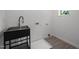 Functional laundry room with black utility sink, tile floors, water hookups, and drain at 160 Daphine Dr, Hillsborough, NC 27278
