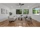 Bright living room with neutral decor, hardwood floors, large windows, and comfortable seating at 160 Daphine Dr, Hillsborough, NC 27278