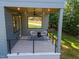 Relaxing covered porch with two chairs, a black and white rug, and peaceful outdoor views at 160 Daphine Dr, Hillsborough, NC 27278