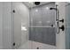 Contemporary tiled shower with glass enclosure, rainfall shower head, and sleek black hardware at 160 Daphine Dr, Hillsborough, NC 27278