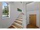 Bright stairway with hardwood treads, white risers, transom window, and light-filled entryway at 160 Daphine Dr, Hillsborough, NC 27278