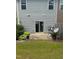Private backyard with a small patio and green lawn perfect for relaxation at 1671 Holly Grove Way, Durham, NC 27713