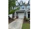 Inviting townhome showcasing a one-car garage and manicured landscaping at 1671 Holly Grove Way, Durham, NC 27713