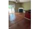 Spacious living room with hardwood floors, a fireplace, and natural light at 1671 Holly Grove Way, Durham, NC 27713