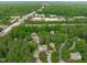 A picturesque aerial of a home nestled among lush greenery and near local retail areas at 1813 Carrington Dr, Raleigh, NC 27615
