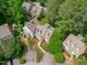An attractive aerial view of a grey home surrounded by lush trees and manicured landscaping at 1813 Carrington Dr, Raleigh, NC 27615
