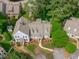 A detailed aerial view of a grey home with lush landscaping and mature shade trees at 1813 Carrington Dr, Raleigh, NC 27615