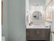 Stylish half bathroom featuring elegant mirror, modern vanity, and marble countertop at 1813 Carrington Dr, Raleigh, NC 27615
