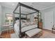 Spacious bedroom featuring a four-poster bed, soft, natural light, and a tasteful decor at 1813 Carrington Dr, Raleigh, NC 27615