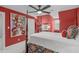 This vibrant primary bedroom features bold red walls, a four poster bed and a large decorative print at 1813 Carrington Dr, Raleigh, NC 27615