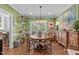 Bright dining room with hardwood floors, stylish table setting and french door detail at 1813 Carrington Dr, Raleigh, NC 27615