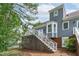 A view of the two-story home's back exterior, showing the deck, stairs, and neutral-colored siding at 1813 Carrington Dr, Raleigh, NC 27615