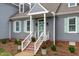 Charming exterior of the home with a white-railed front porch and well-manicured landscaping at 1813 Carrington Dr, Raleigh, NC 27615