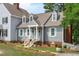 Stylish home with gray siding, light green shutters, and a welcoming brick-lined stairway entrance at 1813 Carrington Dr, Raleigh, NC 27615