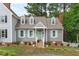 Charming home featuring gray siding, a brick foundation, and light green shutters at 1813 Carrington Dr, Raleigh, NC 27615
