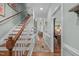 Inviting hallway features hardwood floors, elegant trim, and staircase leading to upper level at 1813 Carrington Dr, Raleigh, NC 27615