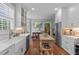Bright kitchen featuring white cabinetry, stainless steel appliances, and a wooden kitchen island with butcherblock top at 1813 Carrington Dr, Raleigh, NC 27615