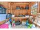 The shed's interior provides ample storage space, shelving, and natural light from a window at 1813 Carrington Dr, Raleigh, NC 27615