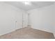 Bright bedroom features neutral carpeting, ceiling fan, and ample closet space at 185 Keller Dr, Clayton, NC 27520
