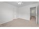 Bedroom showcasing a ceiling fan, neutral walls, and a door at 185 Keller Dr, Clayton, NC 27520