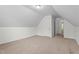 Attic bedroom featuring neutral carpeting, closet storage, and attic access at 185 Keller Dr, Clayton, NC 27520