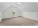 Attic bedroom features neutral carpeting and a window for lots of natural light at 185 Keller Dr, Clayton, NC 27520